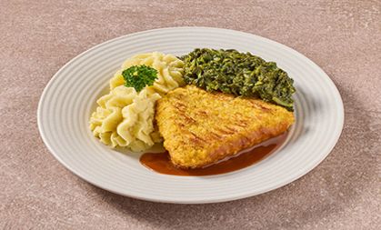 Rijkelijk gevulde cordon bleu met gesneden spinazie en aardappelpuree