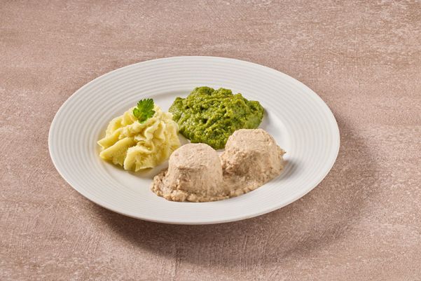 Varkensvlees in jus met erwten en aardappelpuree (gemalen)